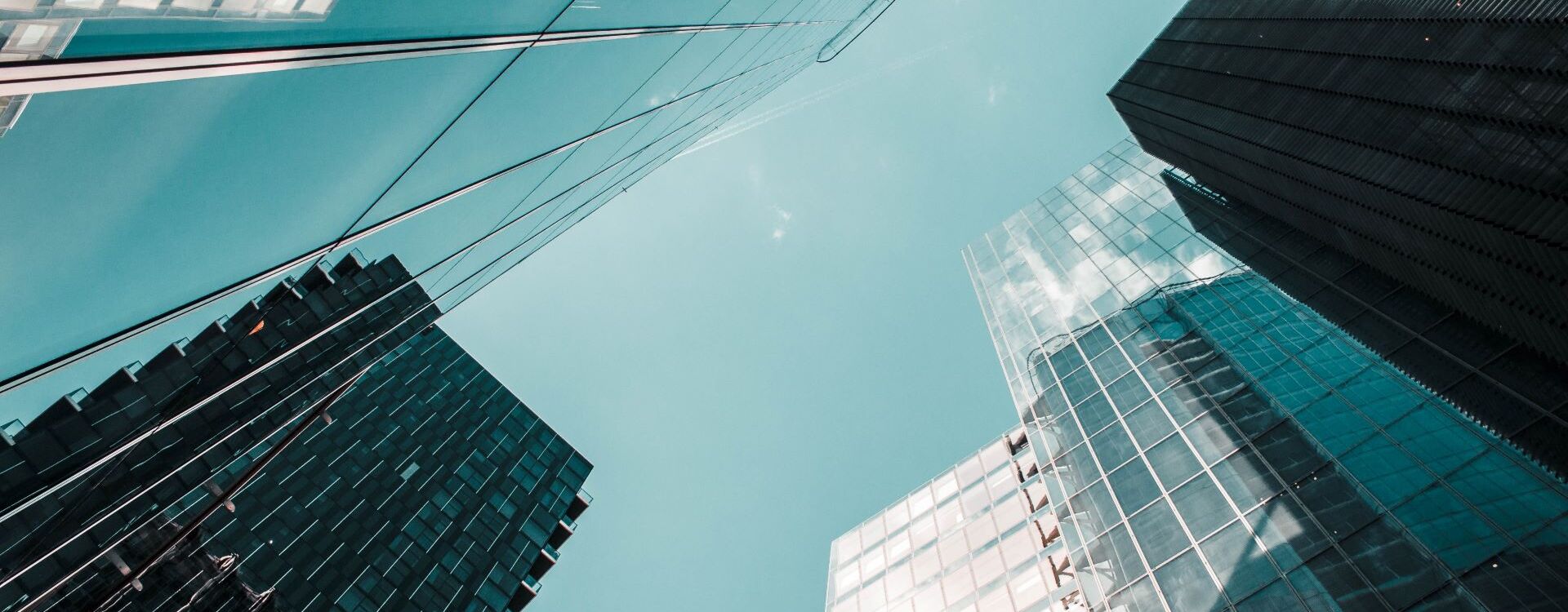 Several skyscrapers towering into the sky from a low-angle perspective